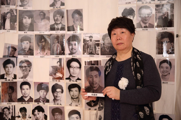 Wu Lihong, wife of Chen Senlin, holds his portrait at the Tiananmen Mothers’ 30th anniversary commemoration of June Fourth victims, March 2019