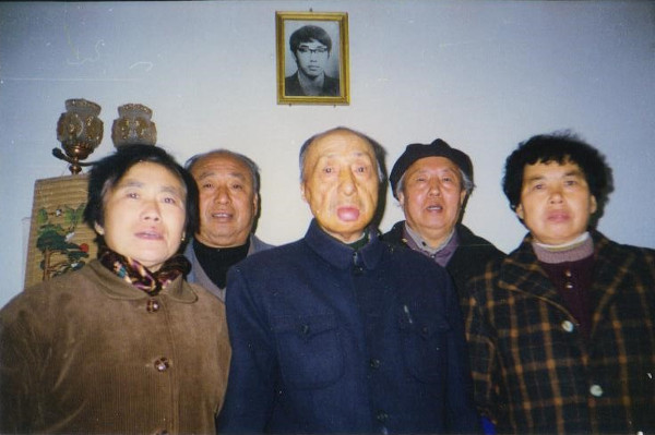Dong Xiaojun’s portrait hanging in the background of this family photo