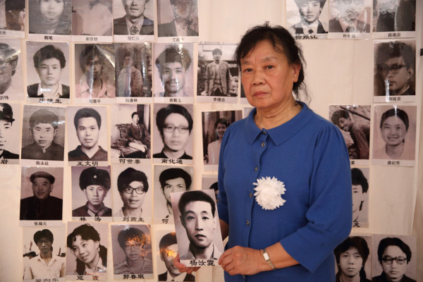 Guo Liying (郭丽英), wife of Yang Ruting, holds his portrait at the Tiananmen Mothers’ 30th anniversary commemoration of June Fourth victims, March 2019