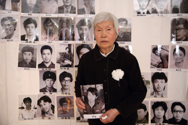 Tan Hanfeng, mother of Yan Wen, holding her son’s portrait at the Tiananmen Mothers’ 30th anniversary commemoration of June Fourth victims, March 2019